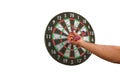 Close up view of male hand pulling out missile of dart board isolated on white background. Royalty Free Stock Photo