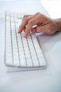 Close up view of a male hand typing on keyboard Royalty Free Stock Photo