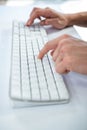 Close up view of a male hand typing on keyboard Royalty Free Stock Photo