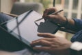 Close up view of male hands holding stylus pen and working on a digital tablet. Blurred background. Horizontal. Royalty Free Stock Photo