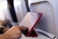 Close up view of male hands using a tablet in a plane. Travel concept Royalty Free Stock Photo