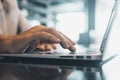 Close up view male hands writes on laptop. Entrepreneur man sit at desk work on modern wireless notebook, do remote telecommute,