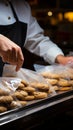 A close up view of a man bagging cookies in a plastic grocery bag