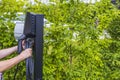 Close up view of a man connecting a charging cable  a car  charging station for electric car. Royalty Free Stock Photo