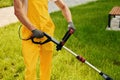 Close up view. Man cut the grass with lawn mover outdoors in the yard