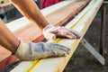 Close up view of a man hands measuring wooden plank with a tape line Royalty Free Stock Photo