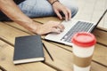 Close-up view of man`s hands working on modern laptop sitting outside the office on stair Royalty Free Stock Photo