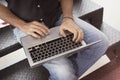 Close-up view of man`s hands working on modern laptop sitting outside the office on stairs Royalty Free Stock Photo