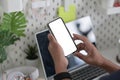 Man sitting at home office desk and using smart phone. Royalty Free Stock Photo