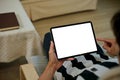 Close up view of a man using blank screen digital tablet on armchair Royalty Free Stock Photo