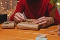 Close-up view of man wrapping Christmas present Royalty Free Stock Photo