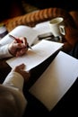 Close up view of a man writing on a piece of paper with a pen Royalty Free Stock Photo