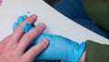 Close up view of man's hand with soft pink skin. Manicurist removes dust from hands usinf pink brush. Meterosexual cares