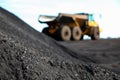 Close up view of Manganese ore with Mining Dump Truck in the background