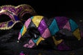 Close-up view of Masquerade gold mask with glitters and confetties on black background