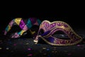 Close-up view of Masquerade mask with confetties on black background