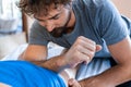 Sports physiotherapist massaging muscular strong man Royalty Free Stock Photo