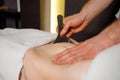 Close-up view of the masseur`s hands performing a abdominal massage abdominal area