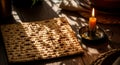 Traditional seder plate matzah and burning candle lit by warm sunlight shadows Royalty Free Stock Photo