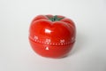 Close up view of mechanical tomato shaped kitchen clock timer for cooking and studying. Also used for pomodoro technique for time Royalty Free Stock Photo