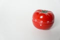 Close up view of mechanical tomato shaped kitchen clock timer for cooking and studying. Also used for pomodoro technique for time