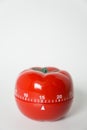 Close up view of mechanical tomato shaped kitchen clock timer for cooking and studying. Used for pomodoro technique for time and Royalty Free Stock Photo