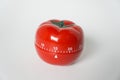 Close up view of mechanical tomato shaped kitchen clock timer for cooking and studying. Used for pomodoro technique for time and