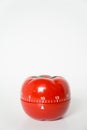 Close up view of mechanical tomato shaped kitchen clock timer for cooking and studying. Used for pomodoro technique for time and Royalty Free Stock Photo