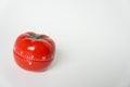 Close up view of mechanical tomato shaped kitchen clock timer for cooking and studying. Used for pomodoro technique for time and