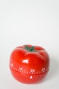 Close up view of mechanical tomato shaped kitchen clock timer for cooking and studying. Used for pomodoro technique for time and Royalty Free Stock Photo