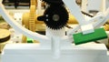 Close-up view of mechanism with black plastic gears and axis with small plate rotating on the circle. Media. Different