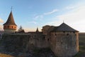Close up view of medieval Kamianets-Podilskyi Castle. Thick stone walls and tall towers. Colorful vibrant sky during sunset. Royalty Free Stock Photo
