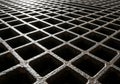 A close-up view of a metal grid structure, showcasing a pattern of square openings. Royalty Free Stock Photo