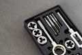 Metallic tap and die set for threading operations displayed in black storage case, precise metalworking tools for creating or Royalty Free Stock Photo