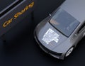 Close-up view of metallic gray electric car with car sharing graphic pattern on hood
