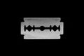 Close up view of metallic razor blade isolated on black background surface Royalty Free Stock Photo
