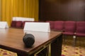 Close up view of microphone on table at press conference hall or seminar room background Royalty Free Stock Photo