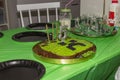 Close up view of minecraft theme for 5 years old birthday party. Black plates and hand made cake on green table cloth background Royalty Free Stock Photo