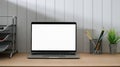 Close up view of minimal workspace with blank screen laptop, office supplies and decorations Royalty Free Stock Photo