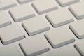 A close-up view of a minimalist white keyboard showcasing its clean, square keycaps in a grid pattern Royalty Free Stock Photo