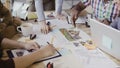 Close-up view of mixed race group of people working at the table. Team discussing architectural design, start-up company Royalty Free Stock Photo