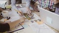 Close-up view of mixed race group of people working at the table. Team discussing architectural design, start-up company Royalty Free Stock Photo