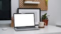 Mock up computer laptop with blank screen on white desk at home office. Royalty Free Stock Photo