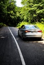 Close-up view of a modern Audi A3 Limousine driving down a sunny road