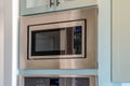 Close up view of modern electric microwave oven inside the kitchen of a home Royalty Free Stock Photo