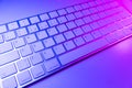 Close up view of a modern laptop computer keyboard keys. Soft lightning. Computer keyboard close up in pink and blue tones Royalty Free Stock Photo