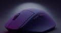 Close up view of a modern purple computer mouse with textured surface and scroll wheel isolated on dark background Royalty Free Stock Photo