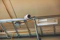Close up view of modern surveillance safety camera under ceiling . Security concept. Royalty Free Stock Photo