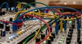 Modular Synthesizer Panel with Colorful Cables and LED Lights Royalty Free Stock Photo