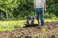 A man plowing garden soil by motor cultivator Royalty Free Stock Photo